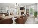 Open-concept living room with a fireplace that connects the living and dining areas, perfect for gatherings at 13032 Windy Lea Ln, Huntersville, NC 28078