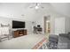 Bright living room features vaulted ceiling, ceiling fan, and a media center with a flat screen TV at 13032 Windy Lea Ln, Huntersville, NC 28078