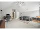 Large living room with vaulted ceilings, ceiling fan, and comfortable gray couch with decor shelves at 13032 Windy Lea Ln, Huntersville, NC 28078