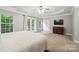 Bright main bedroom offering large windows, a ceiling fan, and carpeted floors at 13032 Windy Lea Ln, Huntersville, NC 28078