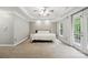 Spacious bedroom featuring neutral tones, a tray ceiling, and large windows for ample natural light at 13032 Windy Lea Ln, Huntersville, NC 28078