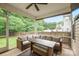 Relaxing screened-in porch with wicker seating area, ceiling fan, and view of the backyard at 13032 Windy Lea Ln, Huntersville, NC 28078