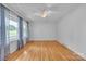 A bright bedroom featuring wood floors, a ceiling fan, and natural light at 133 Jo Monni Loop, Statesville, NC 28625