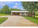 Charming brick home features a covered carport, a well-manicured lawn, and mature trees at 133 Jo Monni Loop, Statesville, NC 28625