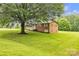 Brick home on a lush green lawn with mature trees and a covered front porch at 133 Jo Monni Loop, Statesville, NC 28625
