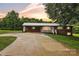 Charming brick home with a metal roof, carport, and a spacious driveway at sunset at 133 Jo Monni Loop, Statesville, NC 28625