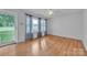 Bright living room featuring wood floors, a ceiling fan, and natural light at 133 Jo Monni Loop, Statesville, NC 28625
