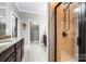 Luxurious bathroom highlighting a glass-enclosed shower and granite countertops for a spa-like experience at 13407 Hazelbrook Ln, Cornelius, NC 28031