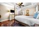 Comfortable bedroom showcasing a ceiling fan, dresser, and an ensuite bathroom for convenience at 13407 Hazelbrook Ln, Cornelius, NC 28031