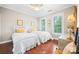 Cozy bedroom featuring two twin beds, hardwood floors, and bright natural light at 13407 Hazelbrook Ln, Cornelius, NC 28031