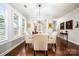 Bright dining area features hardwood floors, plantation shutters, and modern chandelier, creating an elegant space for gatherings at 13407 Hazelbrook Ln, Cornelius, NC 28031