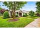 Beautiful home with stone accents, lush landscaping, and a well-maintained front lawn at 13407 Hazelbrook Ln, Cornelius, NC 28031