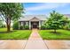 Charming home featuring stone accents, well-manicured lawn, and a welcoming front entrance at 13407 Hazelbrook Ln, Cornelius, NC 28031