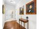 Elegant hallway with hardwood floors, classic artwork and designer accents for a refined aesthetic at 13407 Hazelbrook Ln, Cornelius, NC 28031