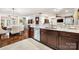This kitchen has stainless steel appliances, granite countertops, and dark cabinets, which flow into the adjacent dining and living areas at 13407 Hazelbrook Ln, Cornelius, NC 28031