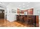 Inviting kitchen bar with wooden cabinets, granite countertops, and stainless steel appliances offers a cozy space for entertaining at 13407 Hazelbrook Ln, Cornelius, NC 28031
