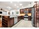 Well-lit kitchen boasts stainless appliances, granite countertops, and wooden cabinets, offering a modern and functional cooking space at 13407 Hazelbrook Ln, Cornelius, NC 28031