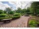 Picturesque landscaping with a brick path and fountain creates a peaceful outdoor space at 13407 Hazelbrook Ln, Cornelius, NC 28031