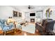 Cozy living room with fireplace, hardwood floors, and comfortable seating, great for relaxing at 13407 Hazelbrook Ln, Cornelius, NC 28031