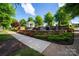 Beautiful water feature with stone accents and a white gazebo nestled in a lush, green community at 13407 Hazelbrook Ln, Cornelius, NC 28031