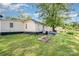 Green backyard featuring a patio, seating area, garden beds, and mature trees at 1406 W Walnut Ave, Gastonia, NC 28052