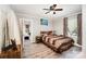Cozy bedroom with hardwood floors, a ceiling fan, and a large window that brings in natural light at 1406 W Walnut Ave, Gastonia, NC 28052