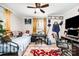 Bedroom featuring a bed, desk, and an array of personal decorations, under a bright ceiling fan at 1406 W Walnut Ave, Gastonia, NC 28052