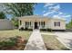 Welcoming home with a charming front porch, perfect for enjoying peaceful outdoor moments at 1406 W Walnut Ave, Gastonia, NC 28052