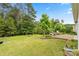 Well-maintained backyard with a brick patio, outdoor seating, and manicured garden beds at 1409 Tupelo Rd, Clover, SC 29710