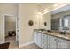 Bathroom featuring double sinks, granite counters, decorative mirrors, and a separate shower at 1409 Tupelo Rd, Clover, SC 29710
