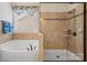 Bright bathroom featuring a tub, glass enclosed shower with seat, and blue accent towels at 1409 Tupelo Rd, Clover, SC 29710