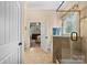 Bright bathroom with a tiled shower and an open doorway to an adjacent bedroom at 1409 Tupelo Rd, Clover, SC 29710