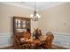 Cozy dining room featuring hardwood floors, a stylish chandelier, and charming wood chairs around a round table at 1409 Tupelo Rd, Clover, SC 29710