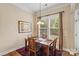 Cozy dining area with a wooden table set for four near a large window with natural lighting at 1409 Tupelo Rd, Clover, SC 29710