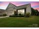 Well-maintained home featuring a lush green lawn, colorful flowers, and manicured shrubbery around the foundation at 1409 Tupelo Rd, Clover, SC 29710