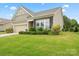 Charming home featuring a manicured lawn with verdant bushes, perfect for a serene and picturesque living environment at 1409 Tupelo Rd, Clover, SC 29710