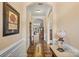 Elegant hallway with hardwood floors, decorative wainscoting, and arched doorways, blending classic style with modern comfort at 1409 Tupelo Rd, Clover, SC 29710