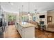 Bright kitchen with granite counters, stainless steel appliances, and large center island opens to living room at 1409 Tupelo Rd, Clover, SC 29710