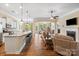 Open concept living room with large kitchen island, fireplace, and hardwood floors, perfect for entertaining at 1409 Tupelo Rd, Clover, SC 29710