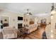 Spacious living room features hardwood floors, a fireplace, and a seamless flow into the dining area at 1409 Tupelo Rd, Clover, SC 29710