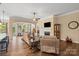 Bright living room with open layout has a fireplace, hardwood floors, and a ceiling fan at 1409 Tupelo Rd, Clover, SC 29710