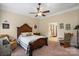 Bright main bedroom with a ceiling fan, upholstered chair, and doorway to the bathroom at 1409 Tupelo Rd, Clover, SC 29710