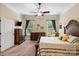 Spacious main bedroom featuring matching dressers, a ceiling fan, and two windows with curtains at 1409 Tupelo Rd, Clover, SC 29710