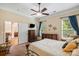 Spacious main bedroom with a ceiling fan, two windows with curtains, and an adjacent seating area at 1409 Tupelo Rd, Clover, SC 29710