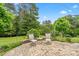 This brick patio features two outdoor chairs and a small table at 1409 Tupelo Rd, Clover, SC 29710