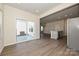 Open living space featuring sliding glass doors to the backyard and a view of the modern kitchen at 1425 Wildflower St, Newton, NC 28658