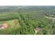 Aerial shot of property showcasing the house, surrounding trees, and landscape at 1513 Shelby Hwy, Cherryville, NC 28021