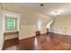 Finished attic with hardwood floors, built-in shelving, storage, and natural light from the windows at 1513 Shelby Hwy, Cherryville, NC 28021