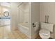 Full bathroom featuring vintage-style wallpaper, tiled floor, shower, tub, and toilet at 1513 Shelby Hwy, Cherryville, NC 28021