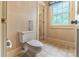 Bathroom with toilet, vintage patterned wallpaper, and bright natural light from the window at 1513 Shelby Hwy, Cherryville, NC 28021
